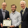 Seth Reid (center) stands with Robert Briley (left) and Dr. Stephen Carls as he accepts the Phi Alpha Theta Scholarship Pin and Academic Excellence Certificate at the history awards banquet on May 3, 2018. Photo by Katherine Cheshire
