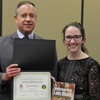 Dr. Henry Allen presents a recognition certificate and a book to Lauren Butler at the history awards banquet on May 3, 2018, for the paper she presented at the Arkansas Phi Alpha Theta Regional Conference on April 7, 2018. Photo by Katherine Cheshire