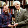 Phi Alpha Theta member Seth Reid (left) accepts Union University's Academic Excellence Medal in History from Dr. Stephen Carls in a special ceremony in Carls's office on May 10, 2018.