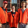 Robert Briley (left to right), Lauren Butler, and Luke Sower show off their safety vests as Phi Alpha Theta volunteers at the “Racing So They Can Ride” 5k and 10k fundraising races on September 15, 2018.