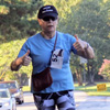 Dr. Alice-Catherine Carls does a thumbs-up as she pushes forward in the “Racing So They Can Ride” 5k event on September 15, 2018.