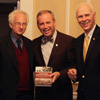 Drs. Melvyn Leffler (left to right), Samuel W. Dub Oliver, and Stephen Carls smile during the presentation of a Leffler book to Union President Oliver at a dinner program that was part of the Carls-Schwerdfeger History Lectureship on October 22, 2018.
