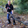 Dr. Henry Allen pulls a large branch to a pick-up point at Liberty Garden Park during the history department's community service project there on November 6, 2018.
