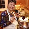Dr. Alice-Catherine Carls prepares a red beet salad at the Phi Alpha Theta French Christmas dinner on December 8, 2018.