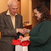 Dr. Stephen Carls presents graduating Phi Alpha Theta member Jessica Barton with a gift bag at the Delta-Psi chapter's French Christmas dinner on December 8, 2018.