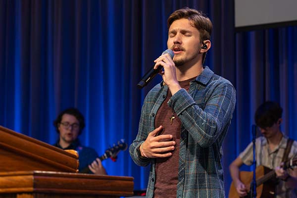 student leading in worship