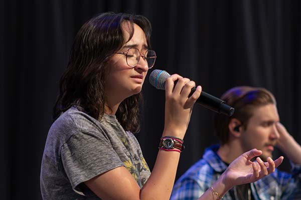 student leading chapel in worship