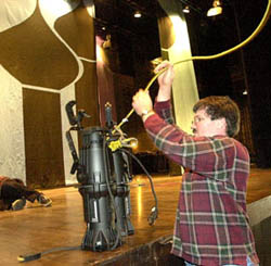 Photo By HELEN COMER/The Jackson Sun - Julian Williamson helps raise lights to the cat walk area at the Carl Perkins Civic Center on Monday as he and others get the stage set for Union University's fourth annual Scholarship Banquet. The keynote speaker will be former Soviet  leader Mikhail Gorbachev.