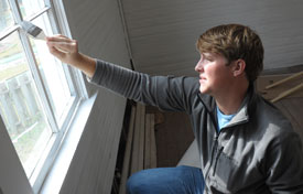 Union sophomore Cale Little helps with the restoration of a 100-year-old church located in Casey Jones Village as part of Campus and Community day. (Photo by Morris Abernathy)