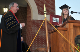 Senior Class President Betsy Davis presents the senior class gift of a new Sugar Shack to President Dockery