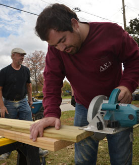 Union University student Jordan Johnson helps local contractor Warren Strickland build a wheelchair ramp at the home of a Jackson man as part of Union's Campus and Community day Nov. 6. (Photo by Morris Abernathy)