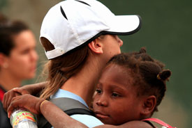 Union University basketball player Paige Parker holds a Haitian girl during the team's recent mission trip to Haiti. 