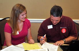 Lacie Fink, an incoming freshman from Mobile, Ala., signs up for classes during new student registration day June 25, with the help of Web Drake, associate professor of communication arts. (Photo by Morris Abernathy)
