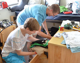 Thomas Gray (left) moves into his Union University apartment with help from his father, Torin. (Photo by Morris Abernathy)