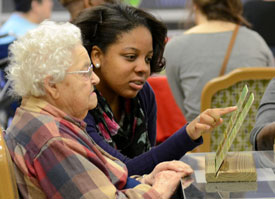 Union University sophomore Angelica Shipps helps a resident play bingo at the Forest Cove Nursing and Rehabilitation Center during last year's Campus and Community: A Day of Remembrance and Service. (Photo by Anne Richoux)