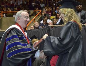 Union President David S. Dockery presents a degree to Victoria Brooks during Saturday's commencement service at Oman Arena. (Photo by Morris Abernathy)