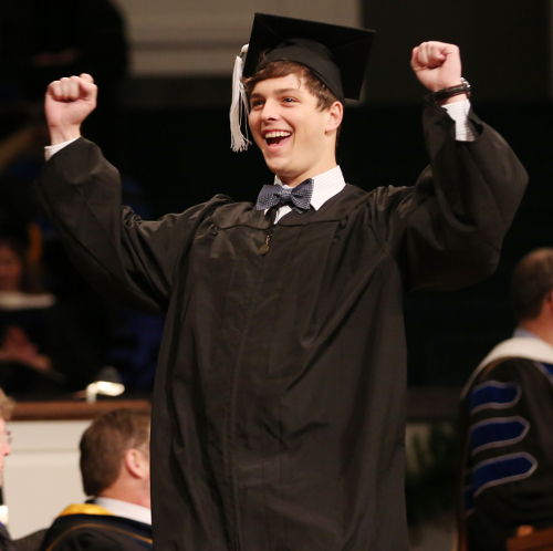 Peyton Penuel, a digital media studies major, celebrates receiving his degree during Saturday's commencement ceremony. (Photo by Kristi Woody)
