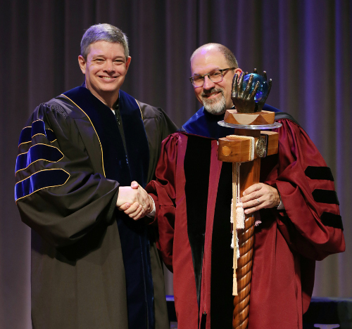 Scott Huelin (right) recipient of the Carla D. Sanderson Faculty of the Year Award on May 5, is congratulated by last year's winner Web Drake. (Photo by Kristi Woody)