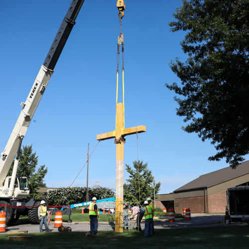 On the morning of July 31, construction crews went to work installing the 17-foot high cross in Hadley Circle. (Photo by Kristi Woody) 