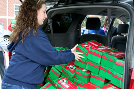 Sophomore Kaitlin Nonweiler helps pack up boxes that were made for Operation Christmas Child during last year's Campus and Community day. (Photo by Deanna Santangelo)