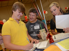 Union freshman Greg Lewis (left) and his father Frank Lewis check in during new student move-in day Aug. 19, while Union enrollment counselor Amy Brown assists. (Photo by Morris Abernathy)