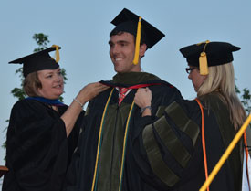 Houston Wyatt (center), one of 41 graduates from Union’s first School of Pharmacy class, receives his hood from Union Provost Carla Sanderson (left) and Kim Jones (right), assistant dean of students in the School of Pharmacy. (Photo by Morris Abernathy)