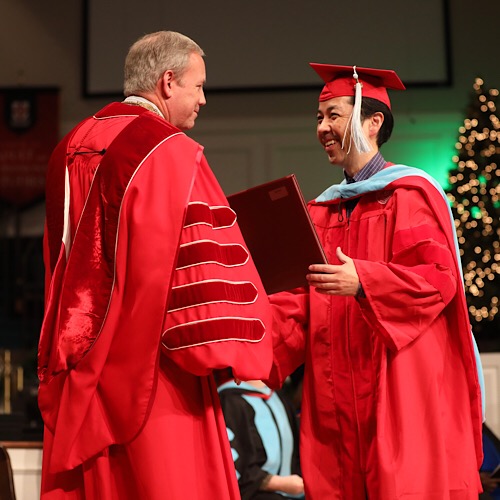 Shu Aoki receives his diploma at fall commencement Dec. 15. (Photo by Kristi Woody)
