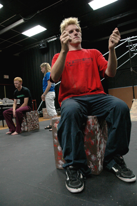 Mr. Samsa, played by Patrick Myers, reads the newspaper as his children, Gregor and Greta, played
by Jared New and Jill Casey, talk in the background during a reheasal for Union's production of
<i>Metamorphosis</i>.