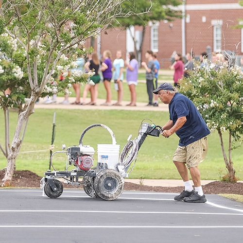 Jackson Seal Coaters finish sealing Union's outdoor basketball court.
