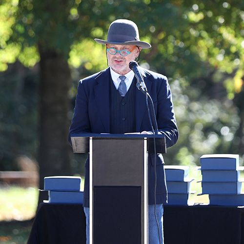 Lee Benson, university professor of art and department chair, speaks at the Oct. 30 dedication ceremony for his new sculpture, “Seven Pillars.” (Photo by Kristi Woody)