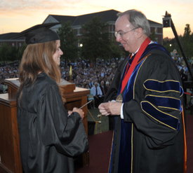 President Dockery presents the 100th Elizabeth Tigrett Medal to Kate Cline during the May 21 graduation ceremony.