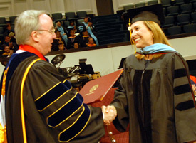 Union University President David S. Dockery presents the university's first Doctor of Education in Higher Education degree to Beverly Absher during the August 3 commencement service at West Jackson Baptist Church. (Photo by Morris Abernathy)