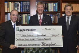 Union University President David S. Dockery (left) accepts a check from BancorpSouth representatives Doug Roth (center) and Gary Grisham on behalf of the Ashby family. (Photo by Morris Abernathy)