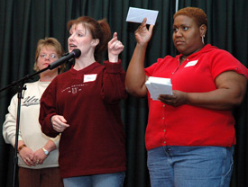 Kris Phifer (center) calls out the names of the children who are getting backpacks.