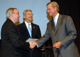 Stephen Reynolds (right), president and CEO of Baptist Memorial Health Care of Memphis, presents a check for $1 million to Union University President David S. Dockery (left) and Harry Smith, chairman of Union's board of trustees. (Photo by Morris Abernathy)