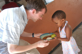 Andy Pettigrew, Union's director of student ministries, helps distribute food to AIDS orphans as part of a GO team mission trip to Botswana. The Botswana team was one of seven GO trips during January. (Photo by Jonathan Blair)