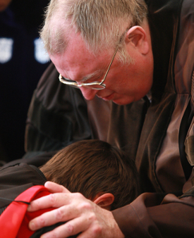 Gerald Bray prays over a student during a consecration ceremony at Samford University. Bray is serving as this year's Scholar-in-Residence at Union. (Photo courtesy Samford University)