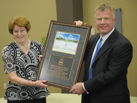 Rod Parker, chairman of Union University's board of trustees, presents a plaque to Maggie Nell Brewer at a luncheon marking the official naming of the Brewer Dining Hall. (Photo by Morris Abernathy)