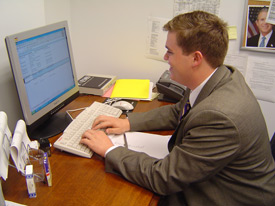Clayton Sanderson works at his desk in the State Department's Office of White House Liaison.