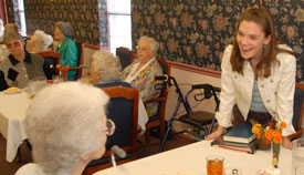 Junior Mattie Trautman visits with residents at the Jackson Oaks Senior Living Community last fall on Union's annual Campus and Community day. (Photo by Morris Abernathy)