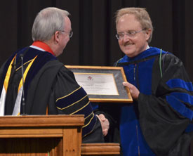 Union President David S. Dockery (left) presents Jimmy Davis with a certificate at his installation as the Hammons Chair of Pre-Medical Studies. (Photo by Morris Abernathy)