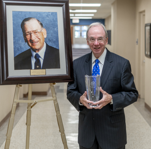 Former Union University President David S. Dockery was awarded with Union's M.E. Dodd Denominational Service Award. Now on the faculty at Southwestern Baptist Theological Seminary in Fort Worth, Texas, Dockery is shown alongside a portrait of Calvin Guy, a Union graduate and longtime professor at Southwestern. (Photo by Adam Covington)