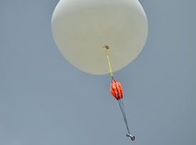A David S. Dockery bobblehead ascends to the borders of space, attached to a high-altitude weather balloon launched by physics students. (Photo by Morris Abernathy)