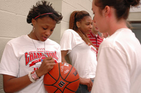 Senior Ena Daniels signs the official championship basketball prior to the April 7 celebration honoring the Lady Bulldogs. (Photo by Kristen Nicole Sayres)