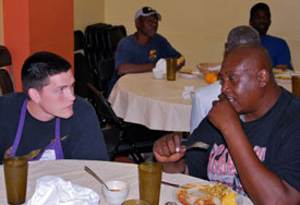 Union sophomore Zach Buck (left) visits with a man at Trinity Cafe, a ministry to the homeless, during a Global Opportunities mission trip to Tampa, Fla., during spring break. (Photo by Jordan Timbs)