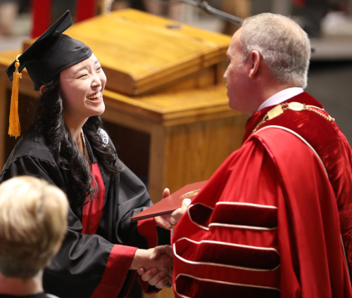 Yee Eun Lee receives her degree from Union President Samuel W. "Dub" Oliver during May's commencement ceremony. (Photo by Kristi Woody)
