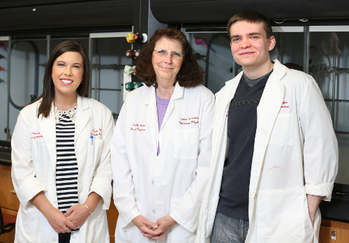 Sally Henrie (center) with Kelsie Wood (left) and Tyler Jones, who helped her with a recently published green chemistry lab manual. (Photo by Kristi Woody)