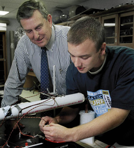 Physics professor Kyle Hathcox works with former Union student Joel Fern on a physics project. (Photo by Jim Veneman)