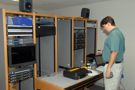 Chris Blair, chairman of the communication arts department, looks over some of the new equipment being installed in Union's broadcasting studio. (Photo by Scott Lancaster)