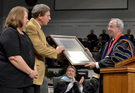 Union President David S. Dockery presents the Robert E. Craig Service Award to Jack and Zan Holmes during Union's Dec. 15 graduation ceremony at West Jackson Baptist Church. (Photo by Morris Abernathy)